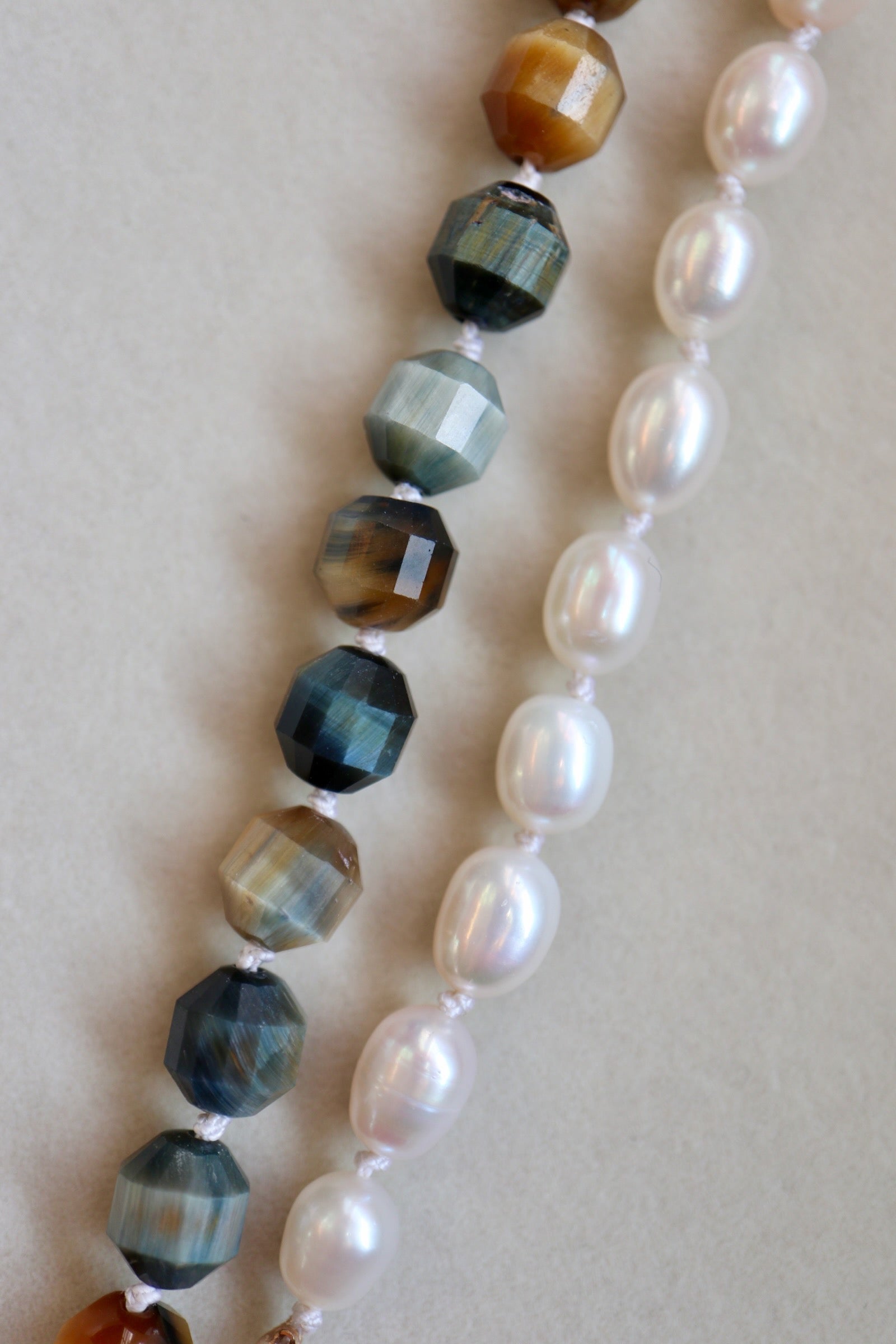 Equina blue tiger eye and freshwater pearl hand-knotted necklace detail by Auréad Designs showing silk cord and individual knots