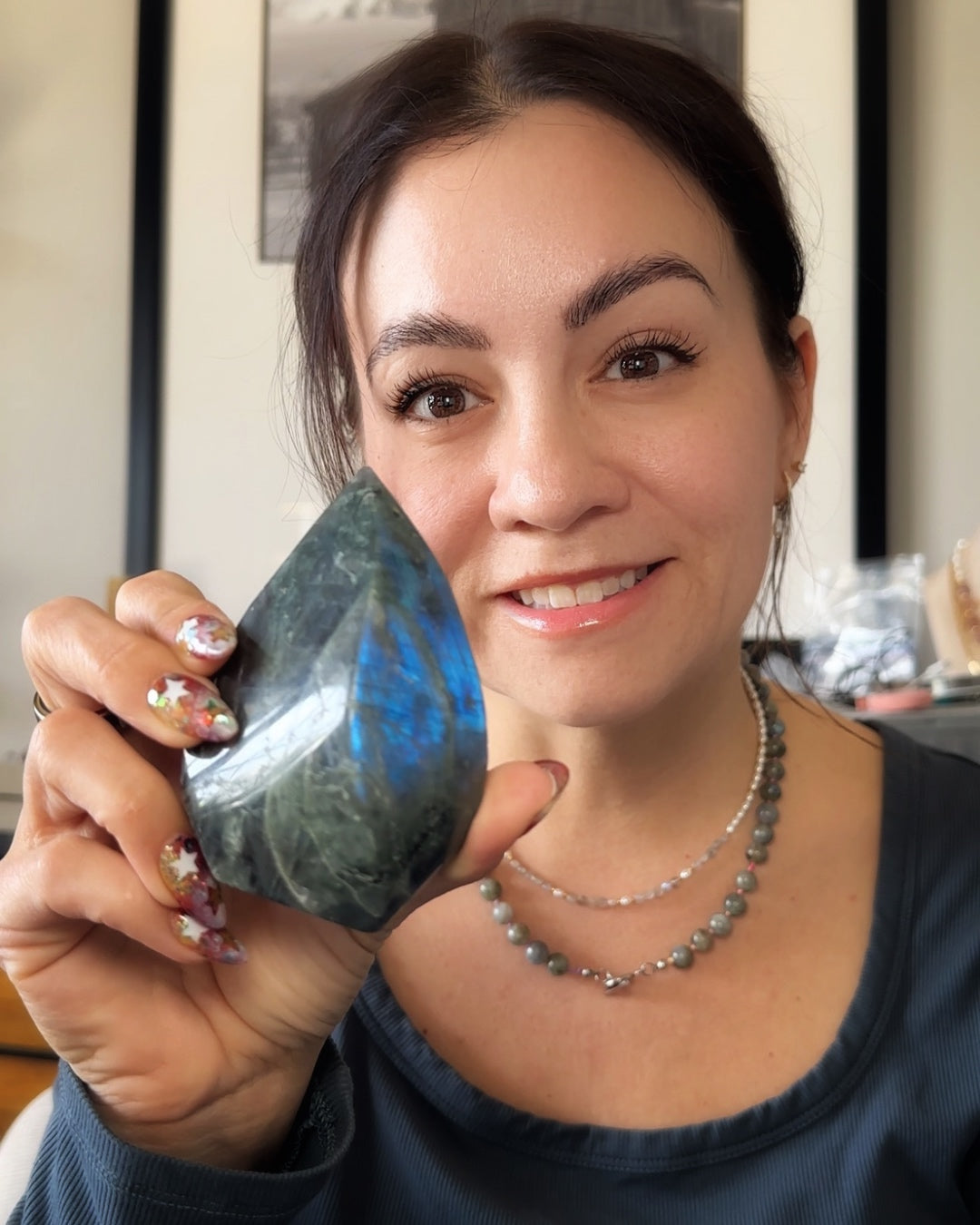 Polished labradorite flame displaying blue iridescent flashes held in hand