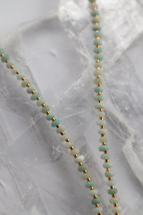 Close-up of the Amara necklace showing the soft blue-green tones of amazonite beads alongside luminous freshwater pearls and gold spacer beads
