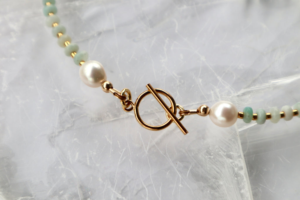 Detail shot of the Amara necklace showing the 14k gold-filled toggle clasp with amazonite beads and freshwater pearls