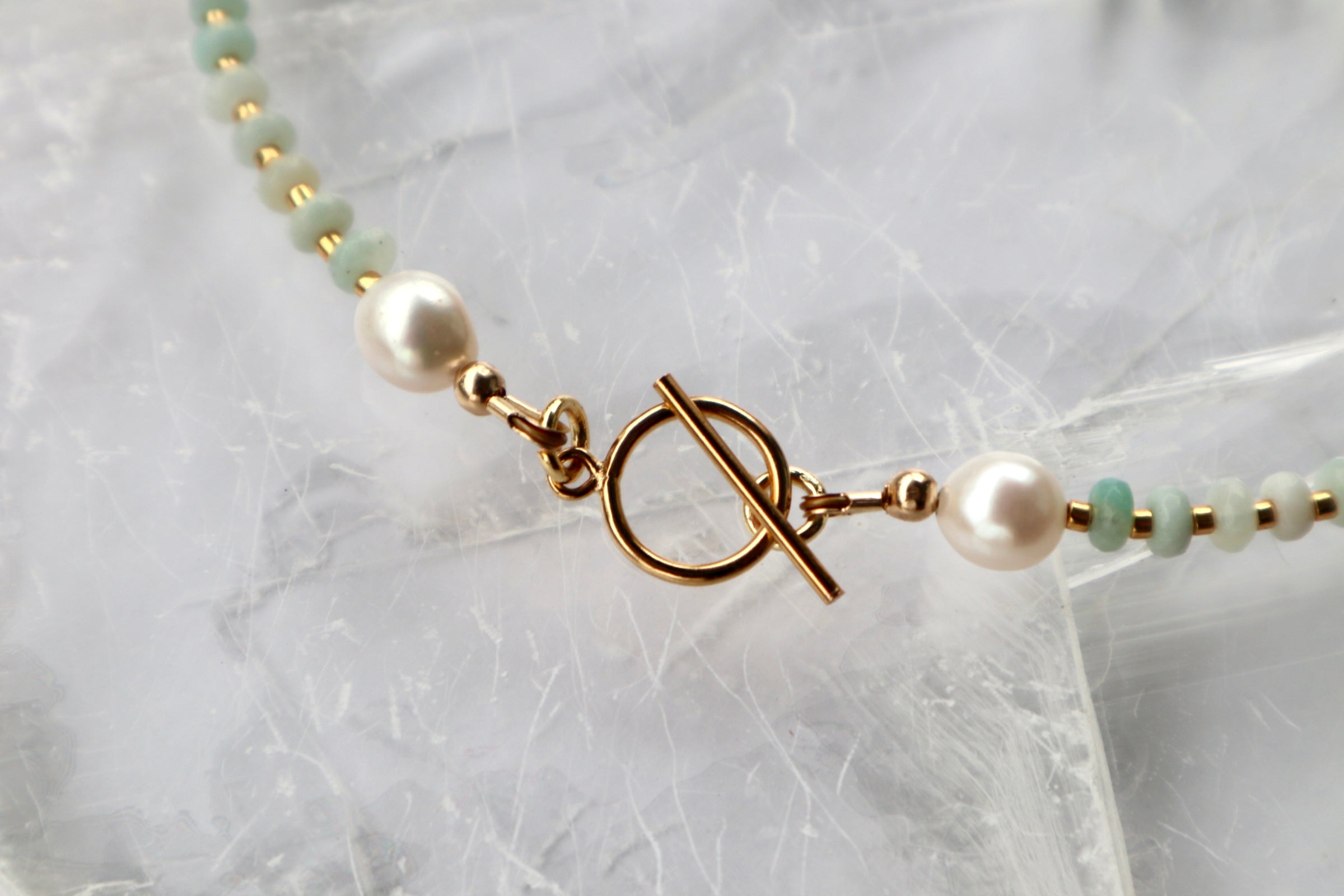 Detail shot of the Amara necklace showing the 14k gold-filled toggle clasp with amazonite beads and freshwater pearls