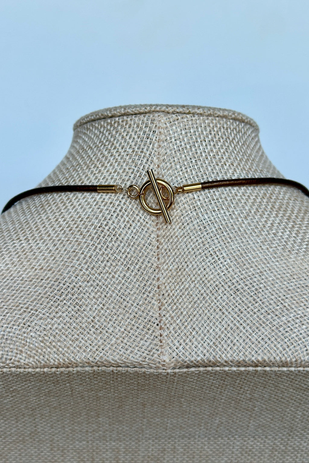 Ardene tiger eye necklace by Auréad Designs, close-up of gold toggle clasp on bronze leather cord