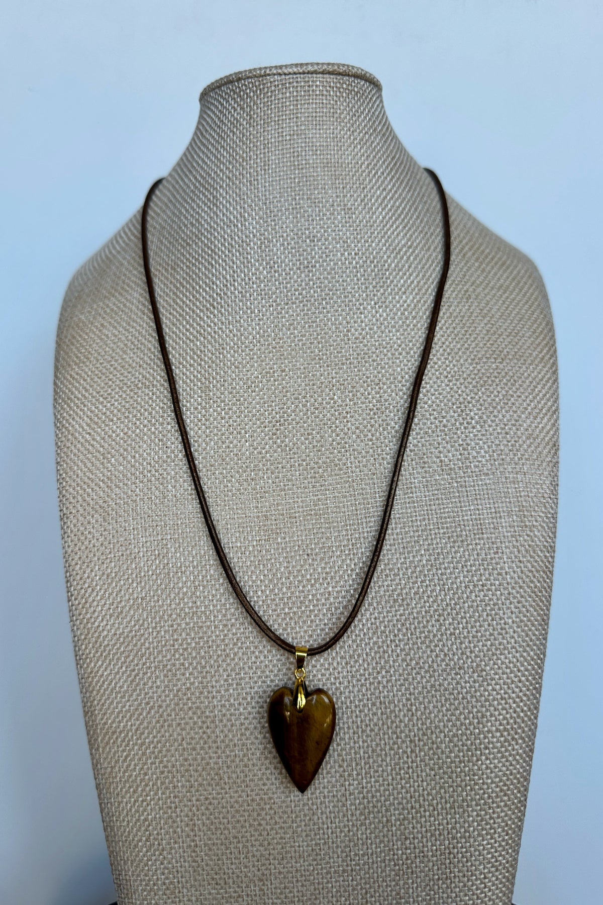Ardene tiger eye heart pendant necklace on bronze leather cord by Auréad Designs on linen bust form
