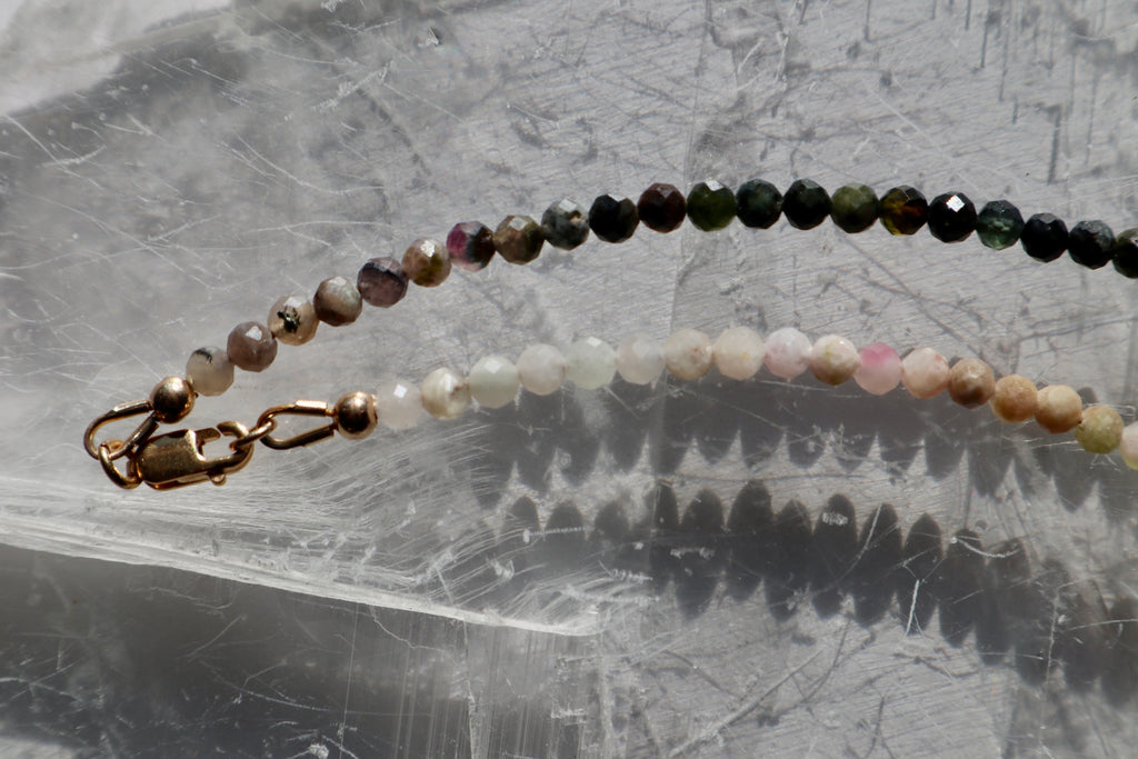  Detail shot of the Aurora necklace showing the 14k gold-filled lobster clasp and the color variation of multicolored tourmaline beads