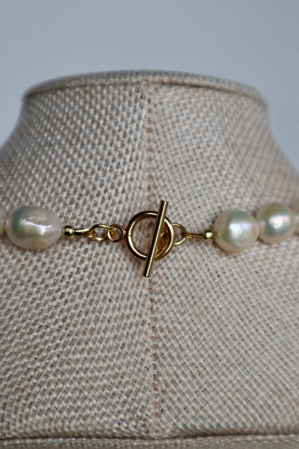 Azurea Maren amazonite and freshwater pearl necklace by Auréád Designs displayed on a linen bust form, featuring large baroque pearls on a gold toggle clasp
