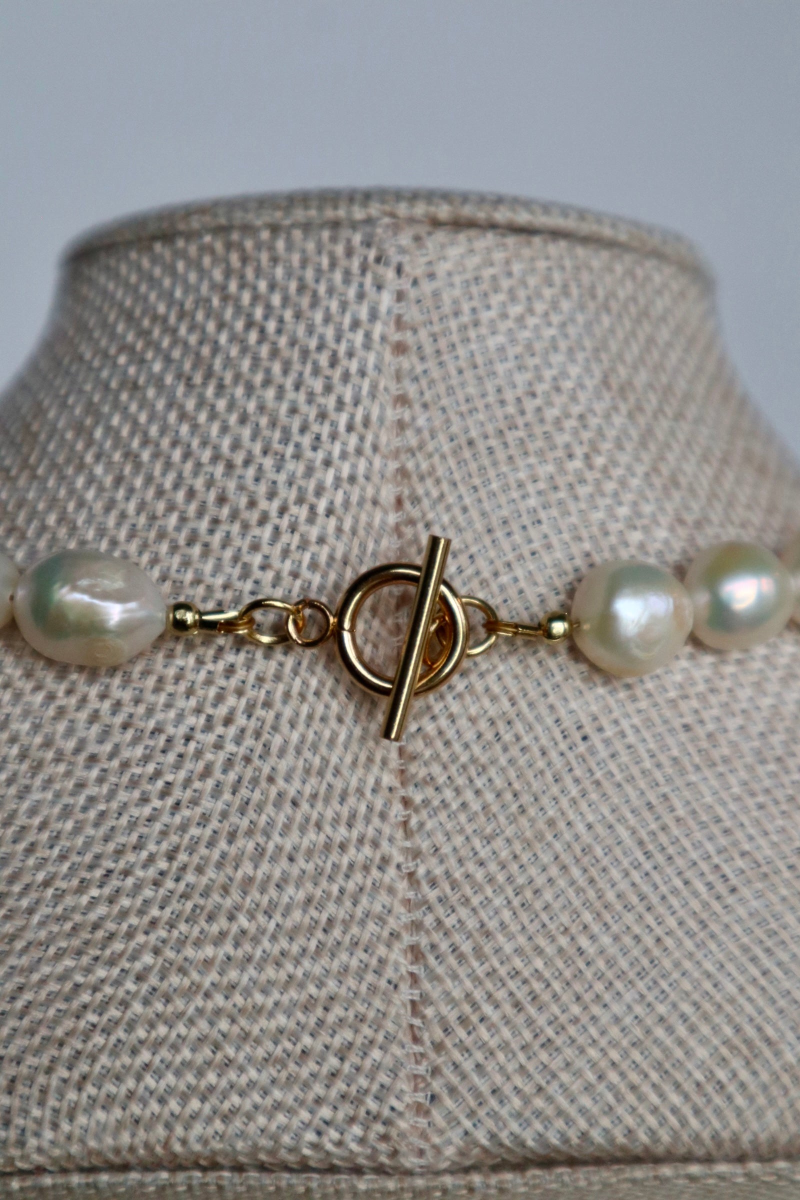 Azurea Maren amazonite and freshwater pearl necklace by Auréád Designs displayed on a linen bust form, featuring large baroque pearls on a gold toggle clasp