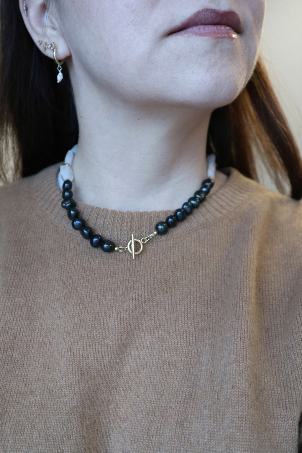 Azurea Noir necklace by Auréad Designs worn with the gold toggle clasp positioned as a front focal point, highlighting the clear quartz and black pearl contrast