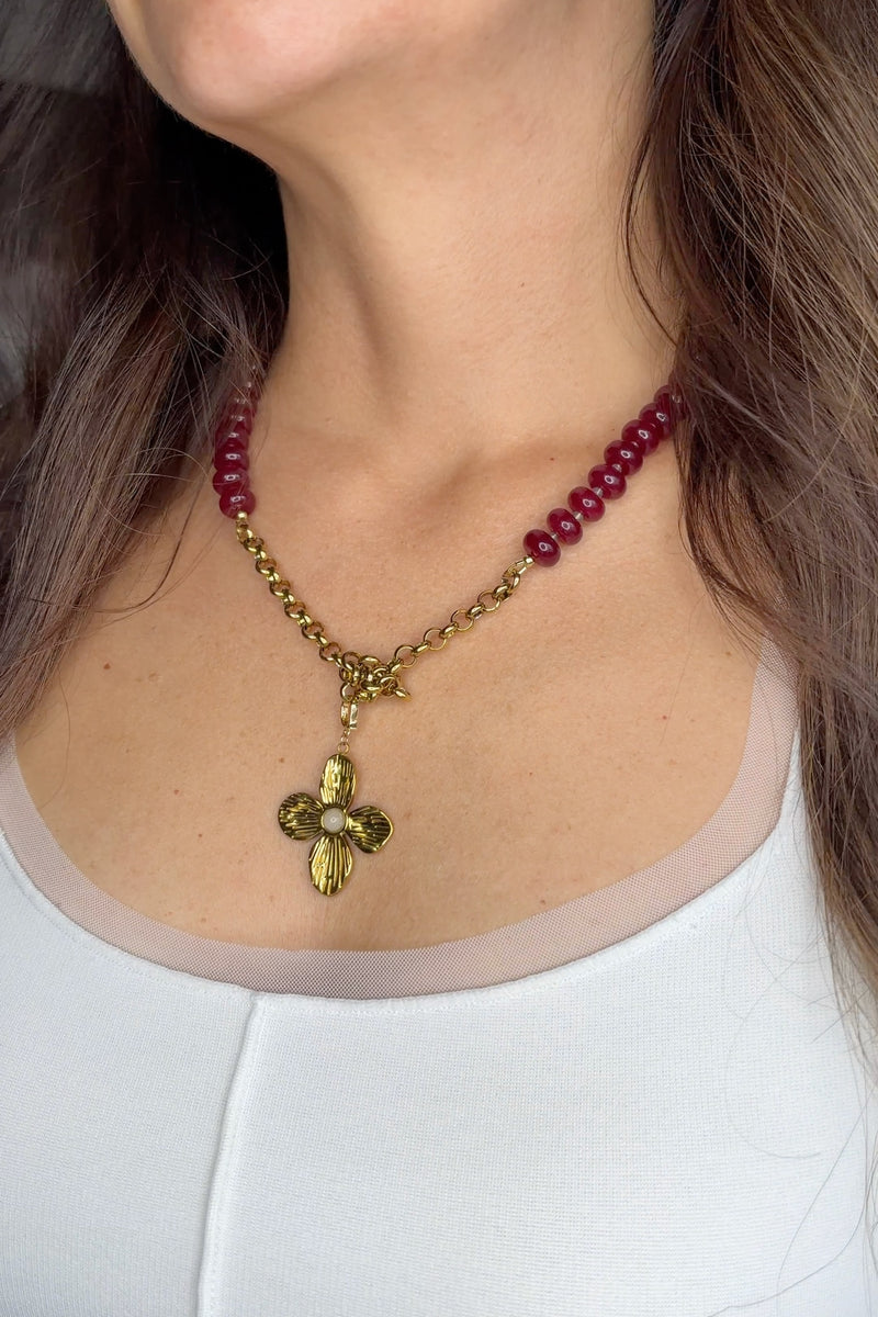 Carmina red jade necklace with gold flower pendant by Auréad Designs, worn with knotted rolo chain and white top