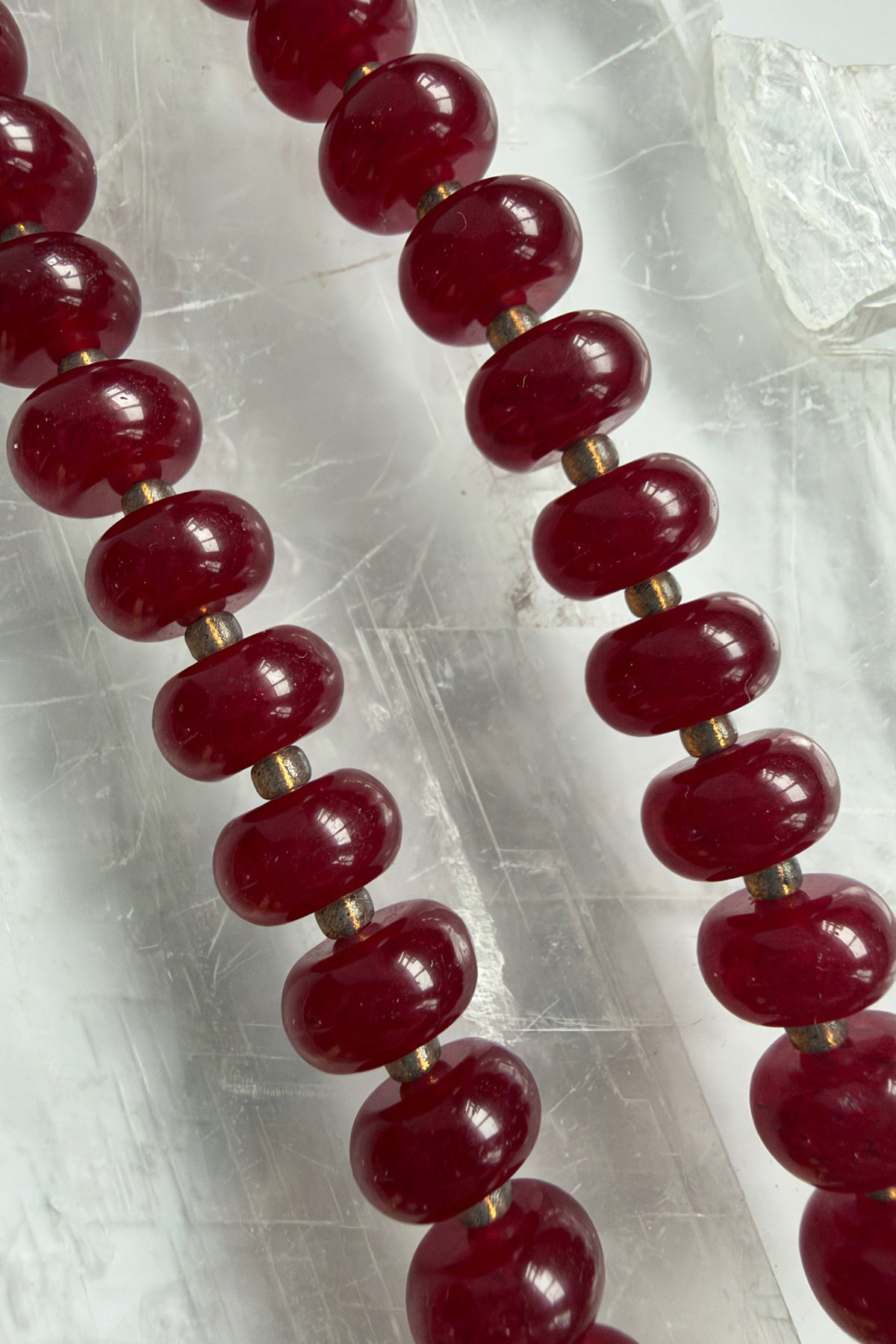 Carmina red jade rondelle beads with glass seed bead spacers by Auréad Designs, close-up texture