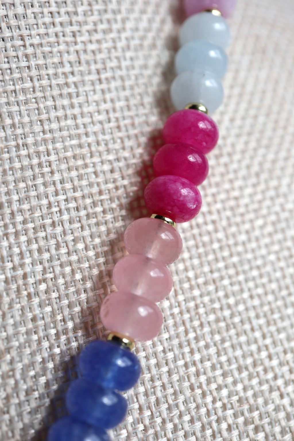 Close-up of the Cherise necklace highlighting the vibrant pink and purple tones of the dyed jade rondelle beads