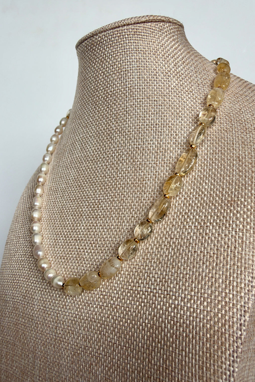 Dawn citrine and freshwater pearl necklace by Auréad Designs on linen bust form, angled view showing pearl and citrine detail