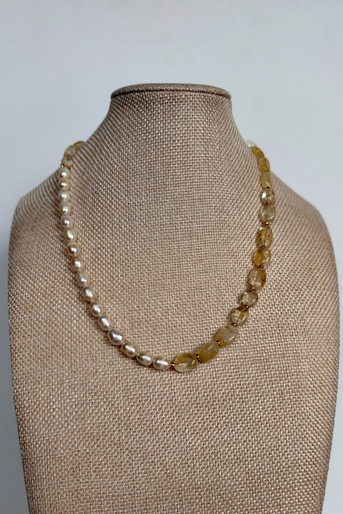 Dawn citrine and freshwater pearl necklace by Auréad Designs displayed on linen bust form, full front view