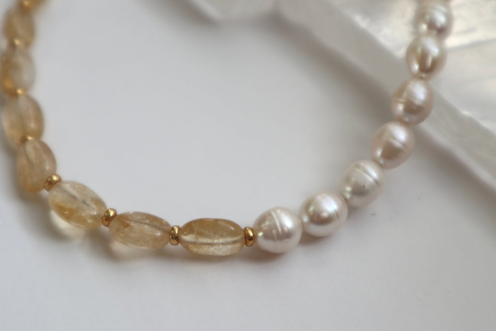 Close-up of the Dawn necklace showing the warm golden tones of citrine gemstone beads alongside luminous freshwater pearls and galvanized gold spacer beads