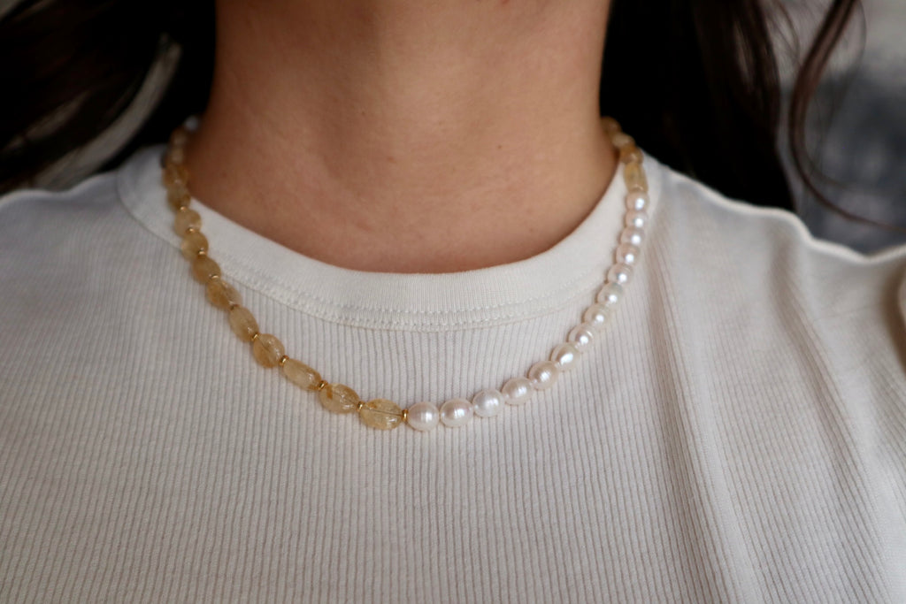 Dawn citrine and freshwater pearl necklace worn at the collarbone, front view, showing the warm sunlit tones of the citrine beads and the gentle contrast of the pearls