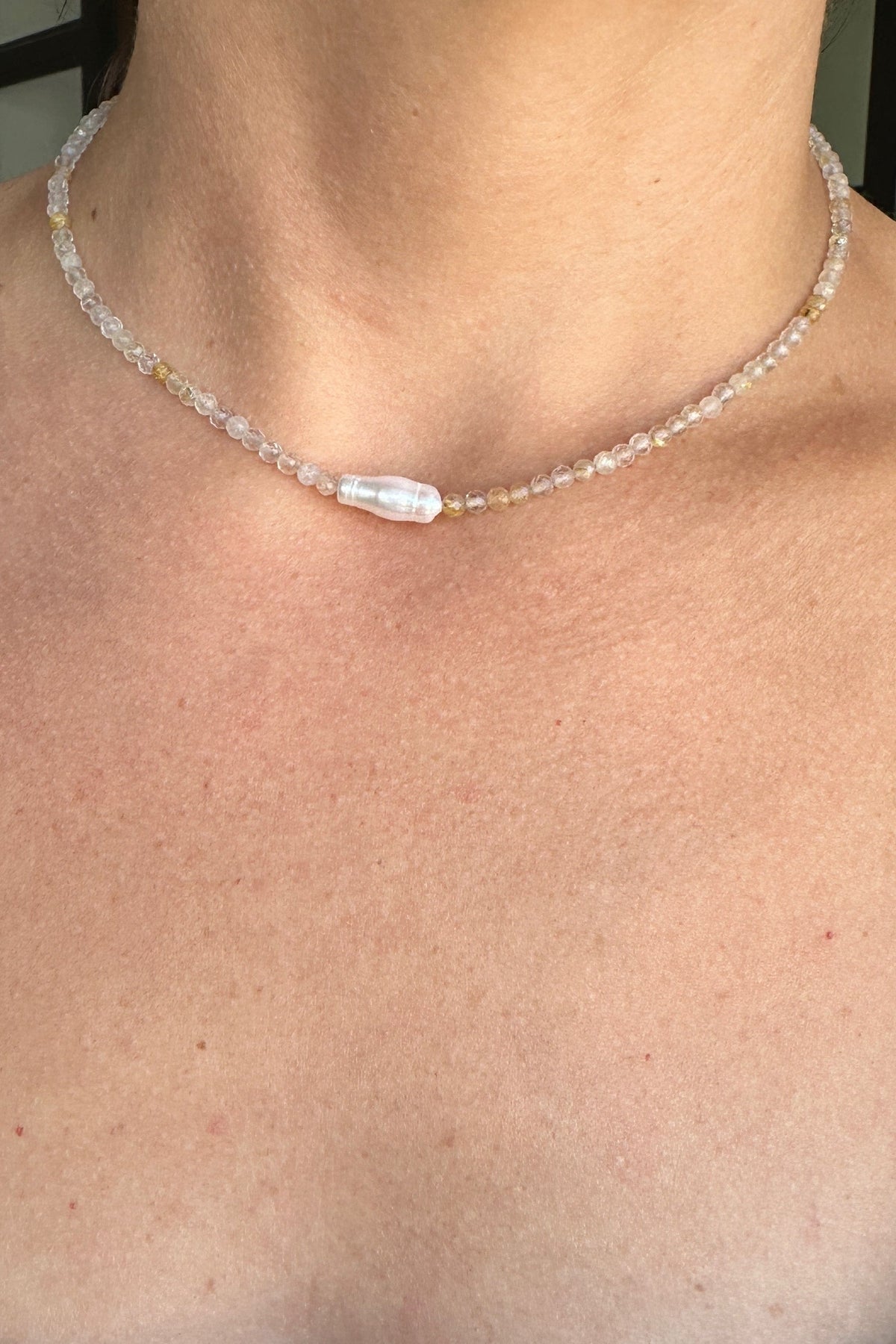 Larch necklace by Auréad Designs worn at the neck, delicate golden rutilated quartz beads with a single baroque freshwater pearl focal bead, from the Glacier Collection