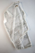 Lumenne herkimer diamond chip necklace by Auréád Designs laid flat on a white selenite slab, showing the full 16-inch strand of icy faceted crystals with 14k gold-filled clasp