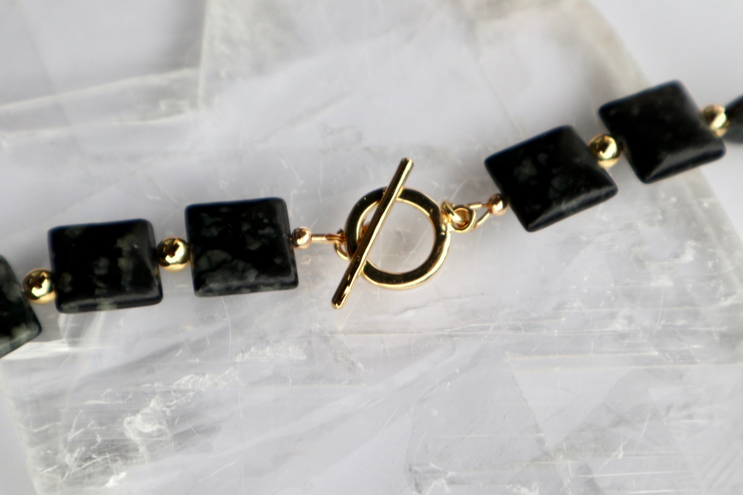 Detail shot of the Morenne necklace highlighting the gold-filled toggle clasp and the sculptural Picasso serpentine pillow beads with their natural earthy patterning