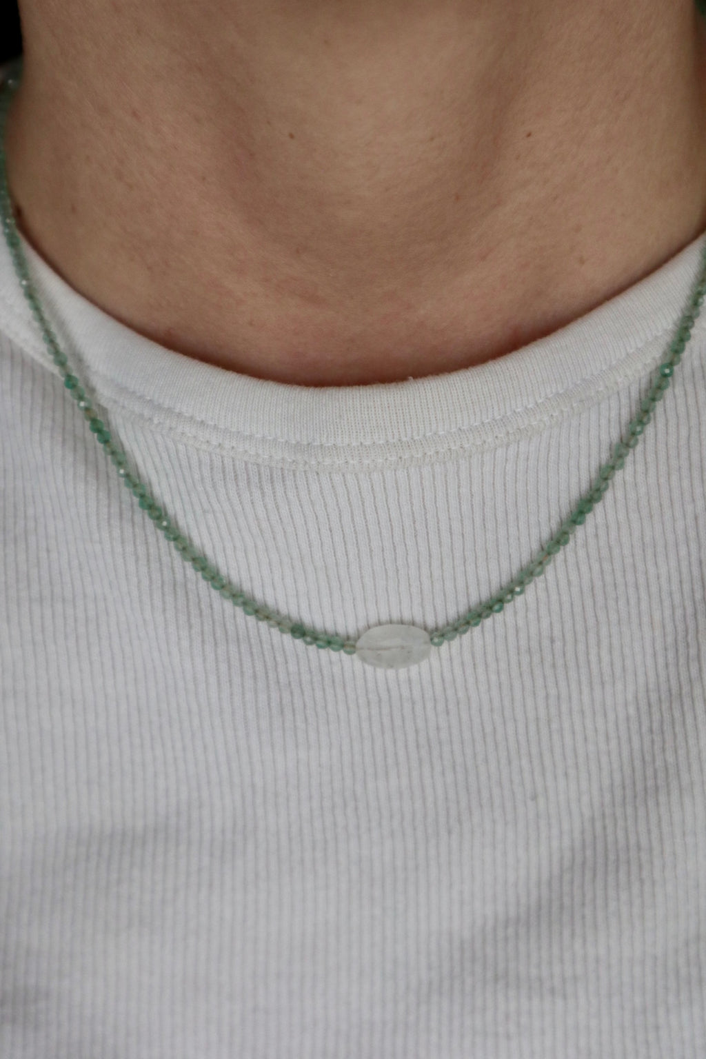 Auréad Designs Primelle necklace worn on neck over a white ribbed top