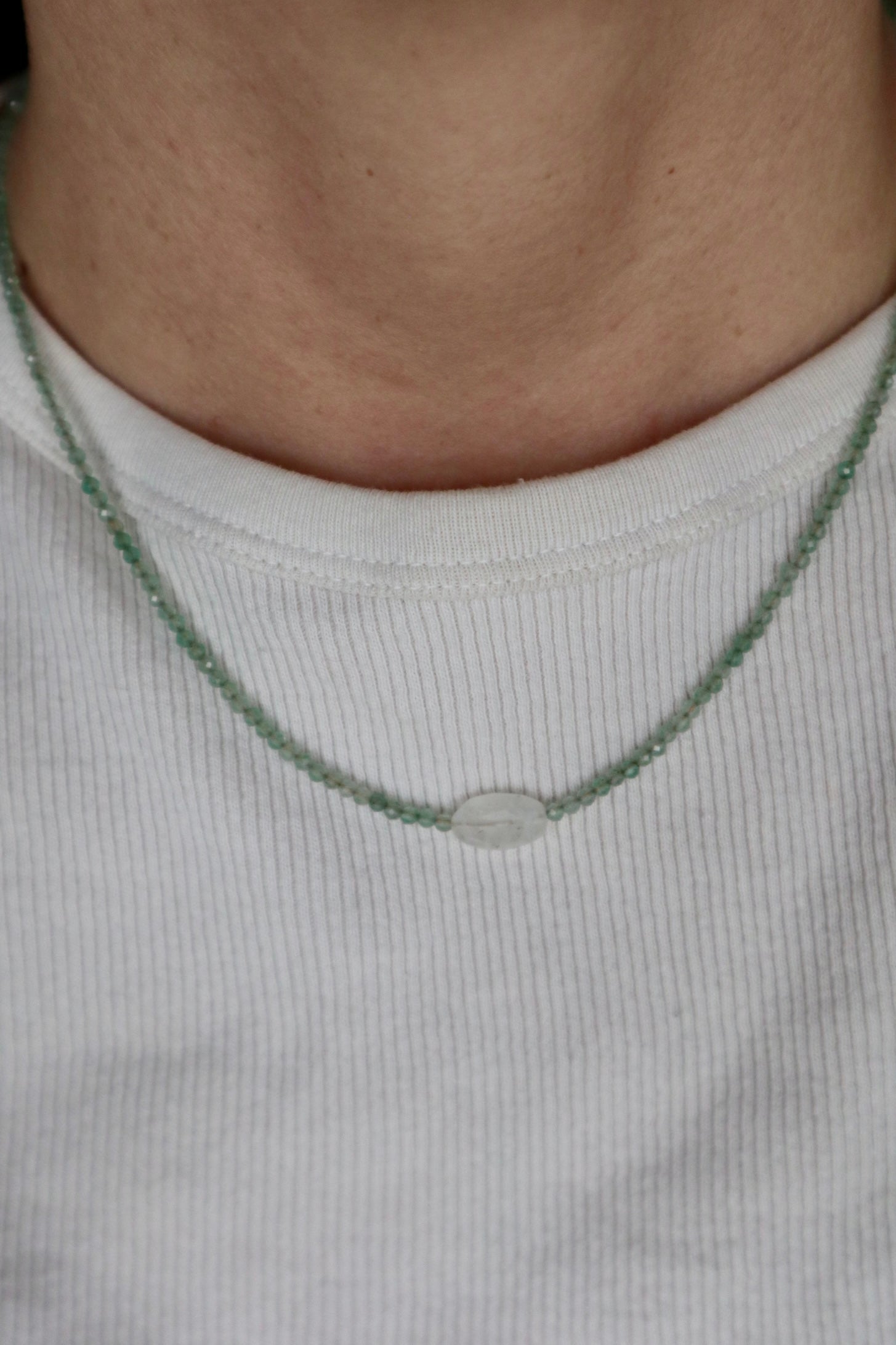 Auréad Designs Primelle necklace worn on neck over a white ribbed top