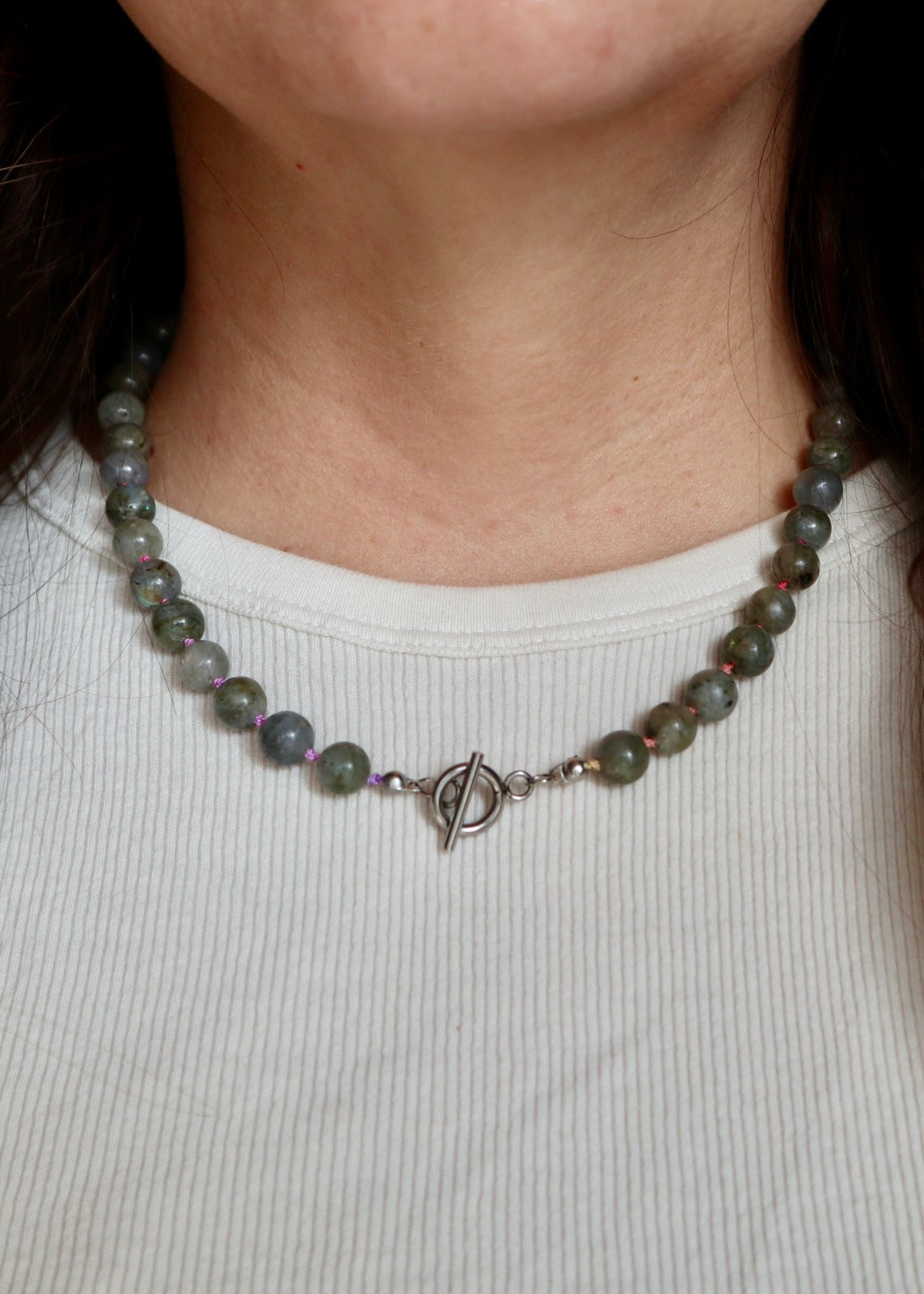 Prism necklace by Auréad Designs worn on model, highlighting the colorful ombré silk cord threading through round labradorite beads against a neutral neckline