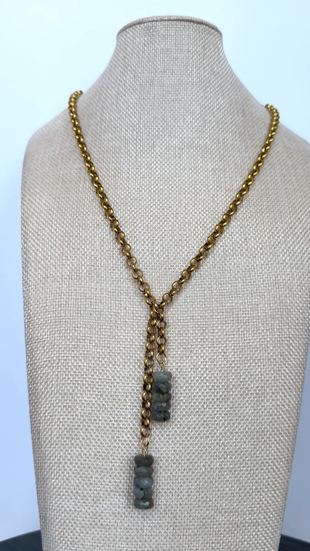 Auréad Designs Rochelle gold rolo chain lariat necklace with stacked labradorite rondelle drops displayed on a linen bust form, front view showing full drape.
