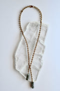 Auréad Designs Rochelle gold rolo chain lariat necklace with labradorite rondelle drop pendants, overhead flat lay on white selenite slab showing full 21-inch length.