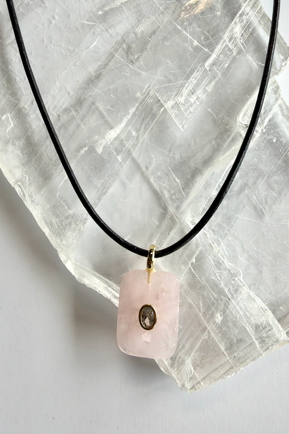 Rosenne rose quartz pendant necklace by Auréad Designs on selenite with leather cord and gold bail