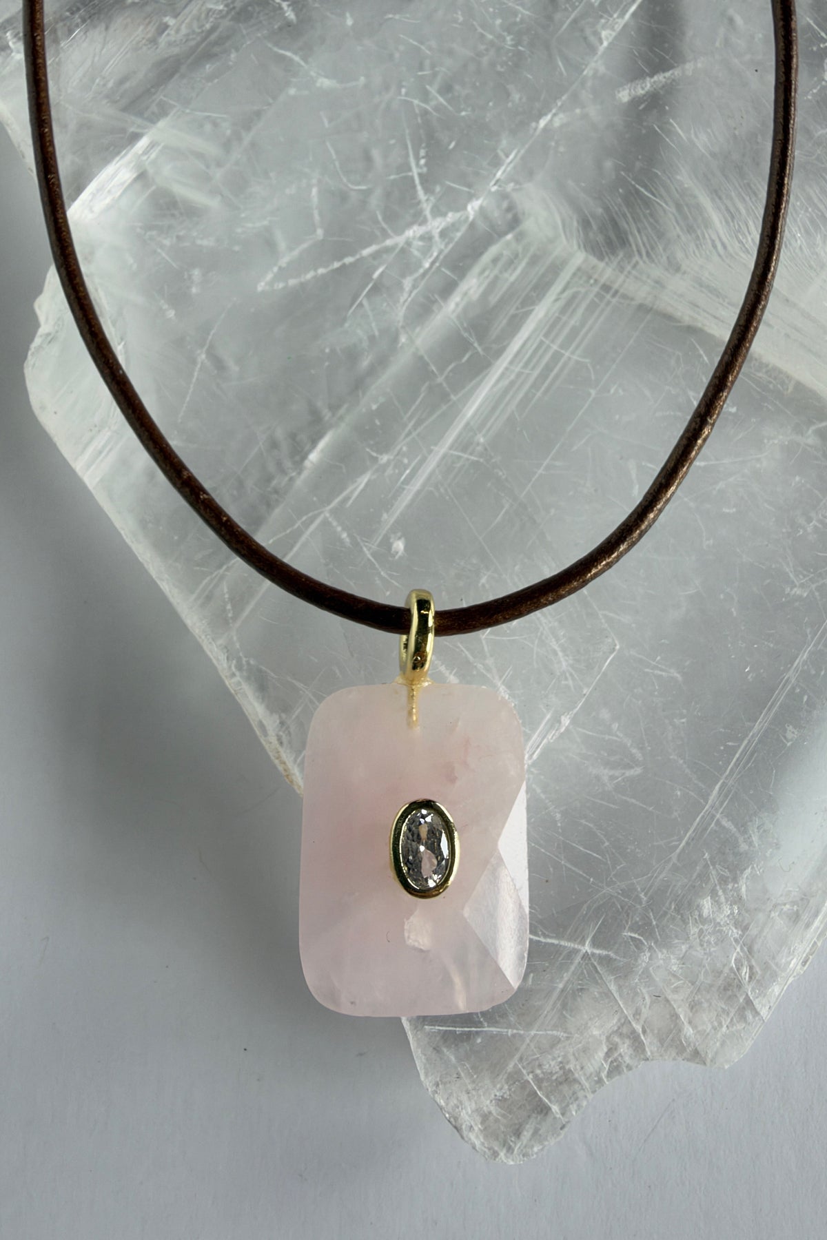Rosenne rose quartz faceted pendant necklace by Auréad Designs, close-up showing CZ center stone and gold bail