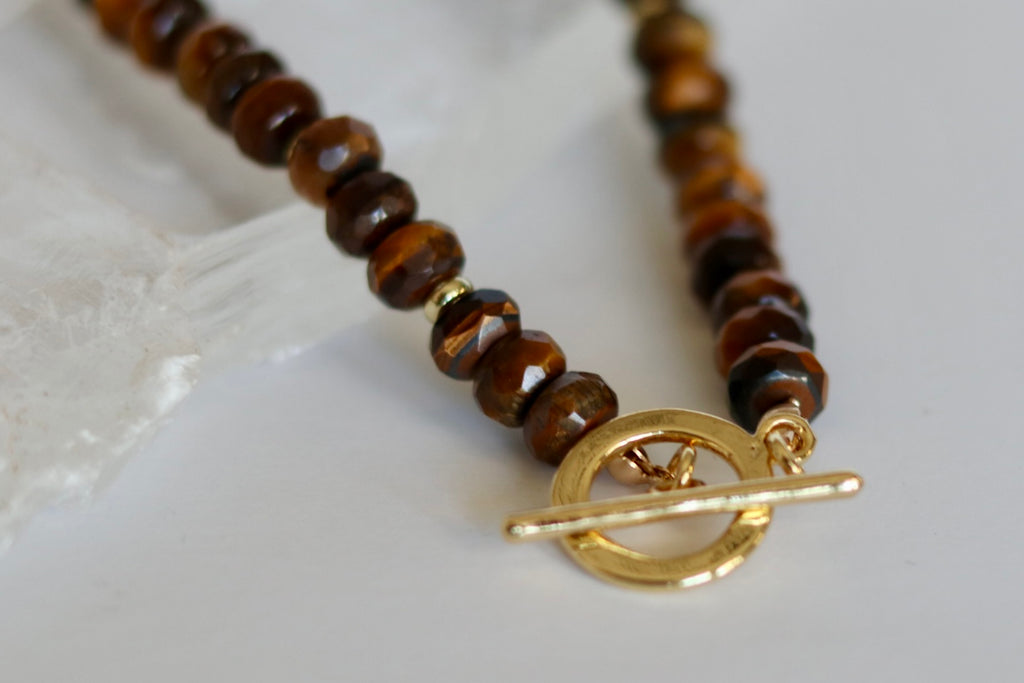 Close-up of the Sable necklace highlighting the natural chatoyancy and warm banding of tiger eye gemstone beads with gold-filled spacers