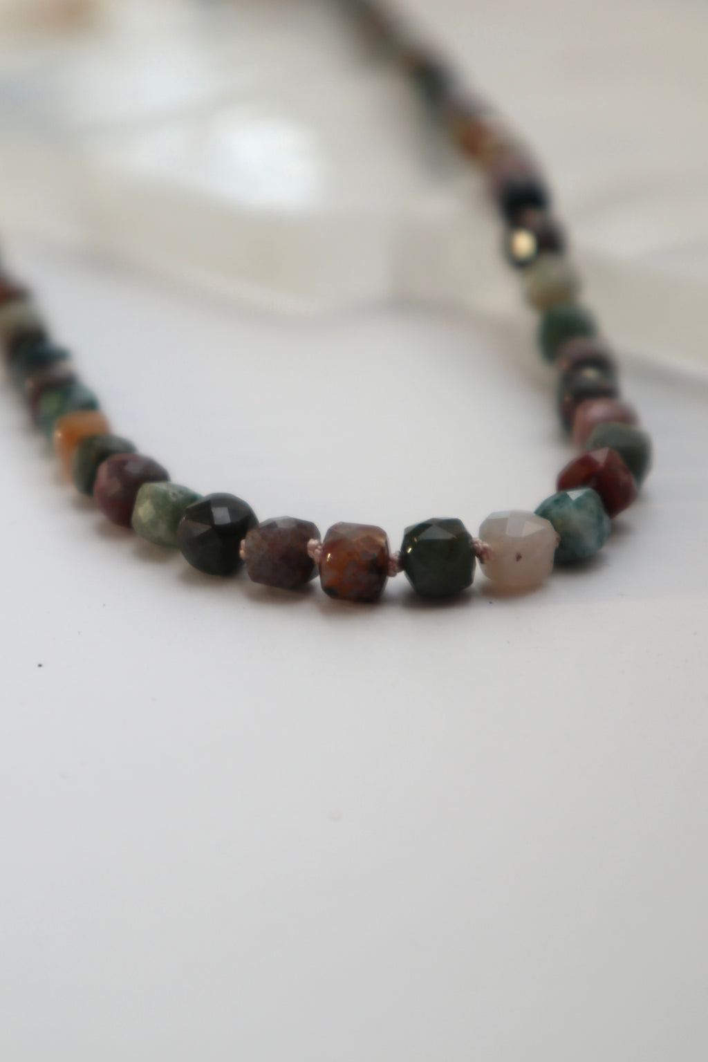 Detail shot of the Siena necklace highlighting the silk knots between beads and the Indian agate beads 