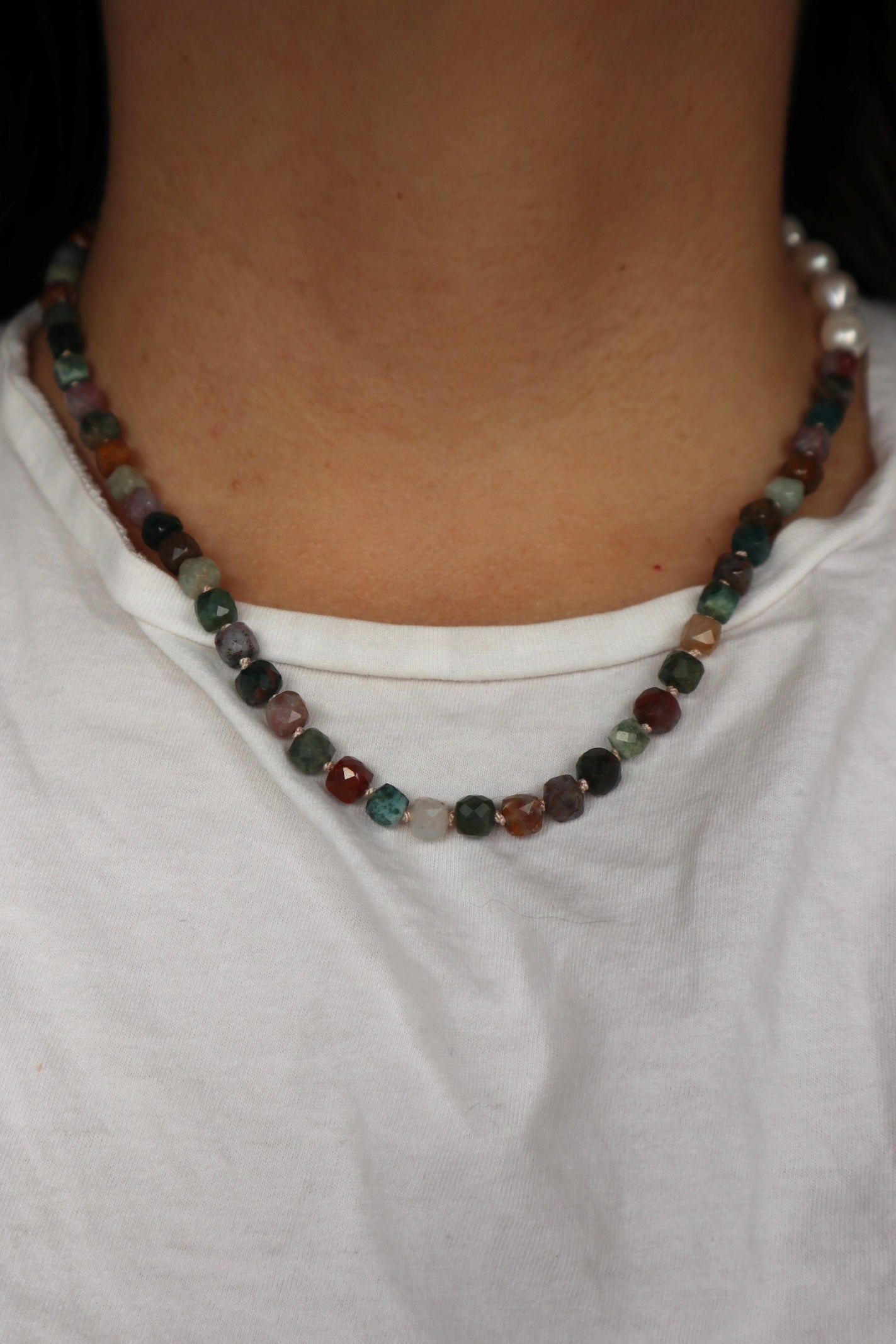 Siena Indian agate and freshwater pearl necklace worn at the collarbone, front view, styled with a white top