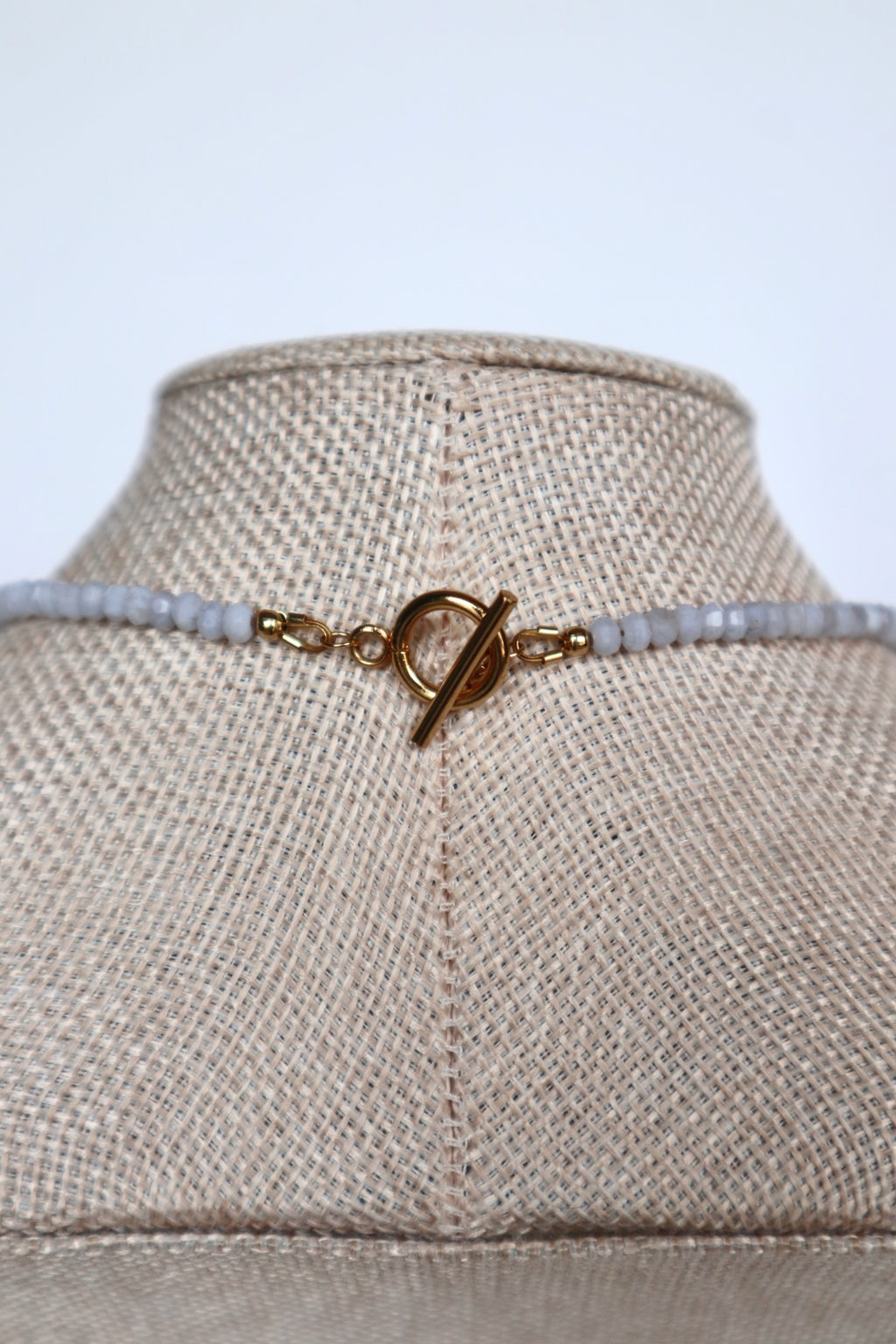 Close-up of the gold toggle clasp on the Sky necklace by Auréad Designs