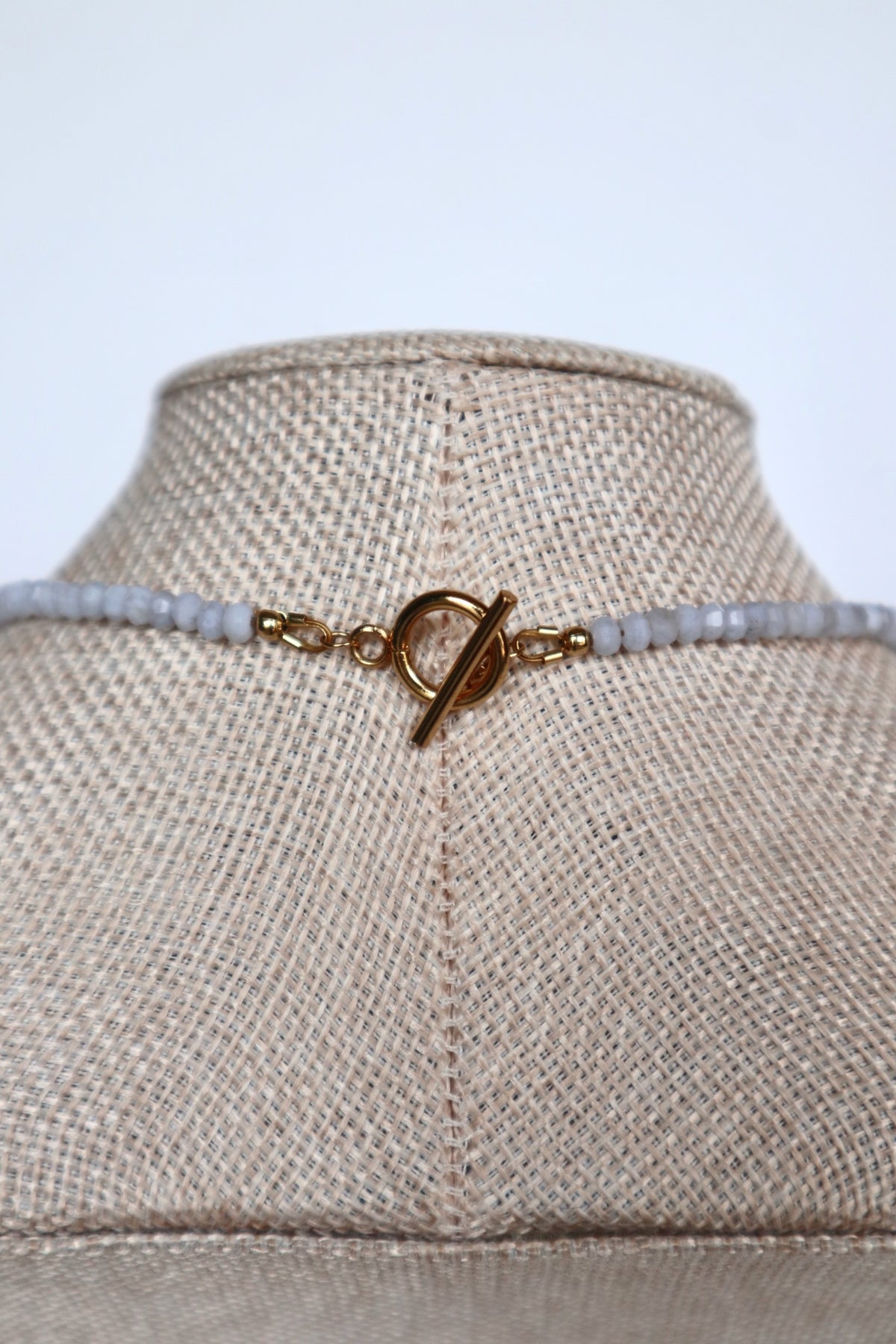 Close-up of the gold toggle clasp on the Sky necklace by Auréad Designs