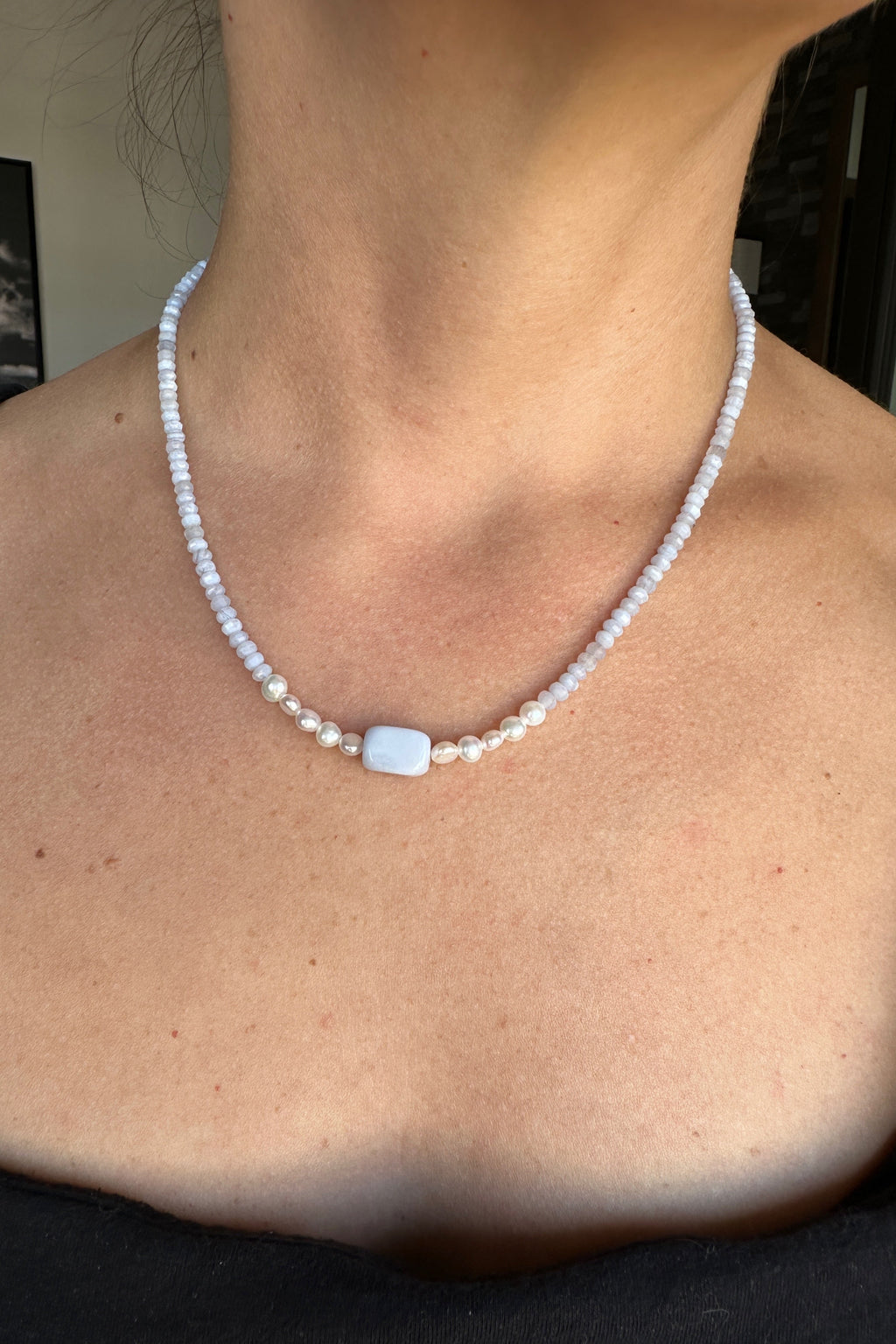 Sky necklace by Auréad Designs worn, showing the full piece with blue lace agate rondelles, freshwater pearl accents, and rectangular focal bead at center
