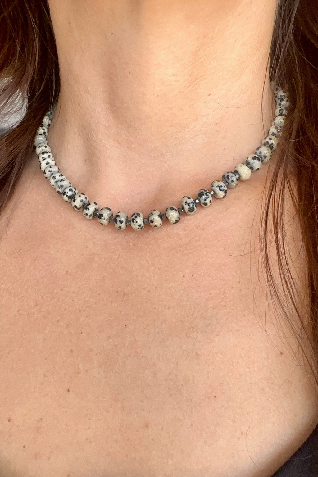 Tessere Dalmatian jasper and hematite beaded necklace by Auréad Designs, lifestyle shot worn at collarbone length