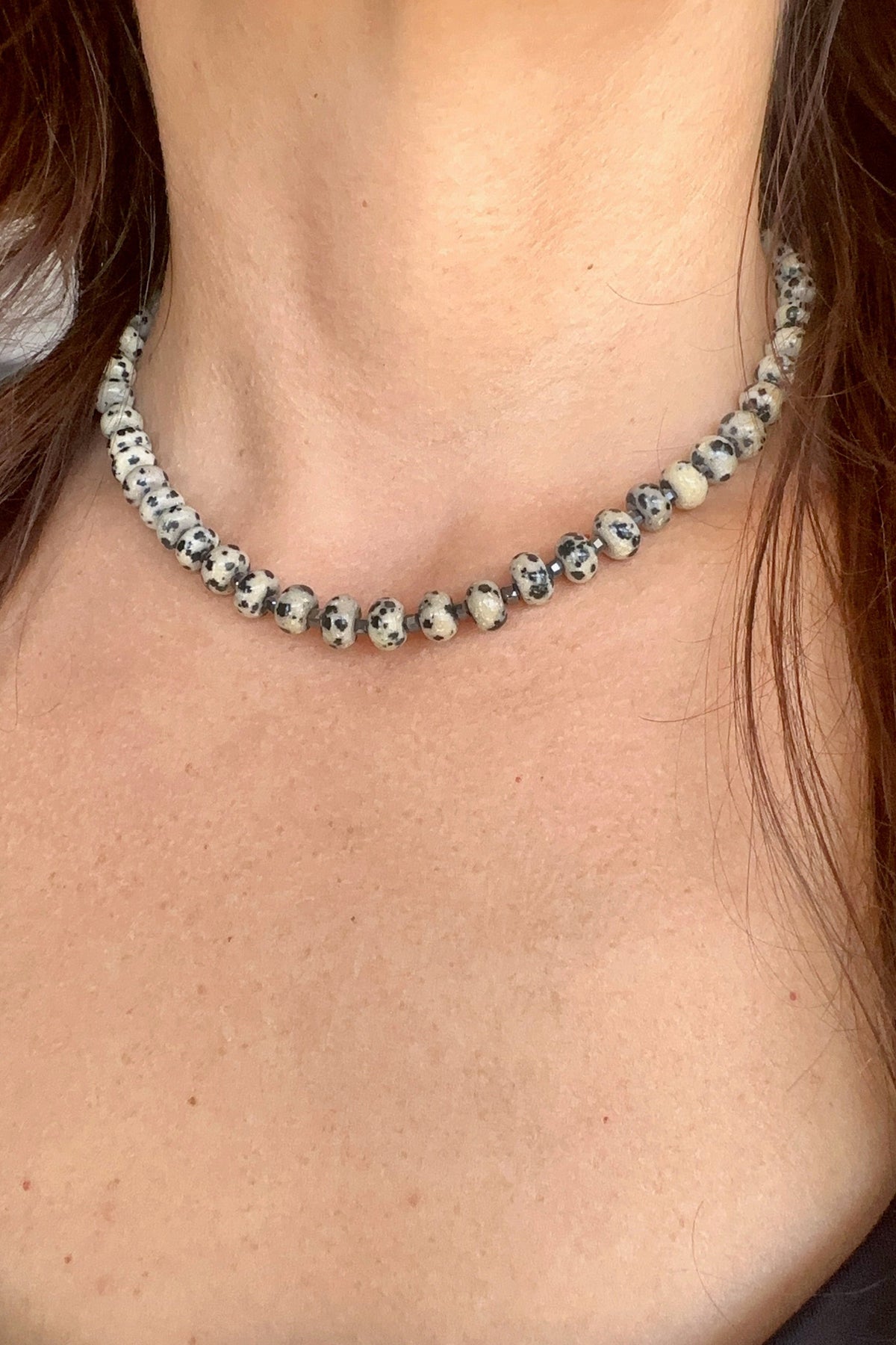 Tessere Dalmatian jasper and hematite beaded necklace by Auréad Designs, lifestyle shot worn at collarbone length