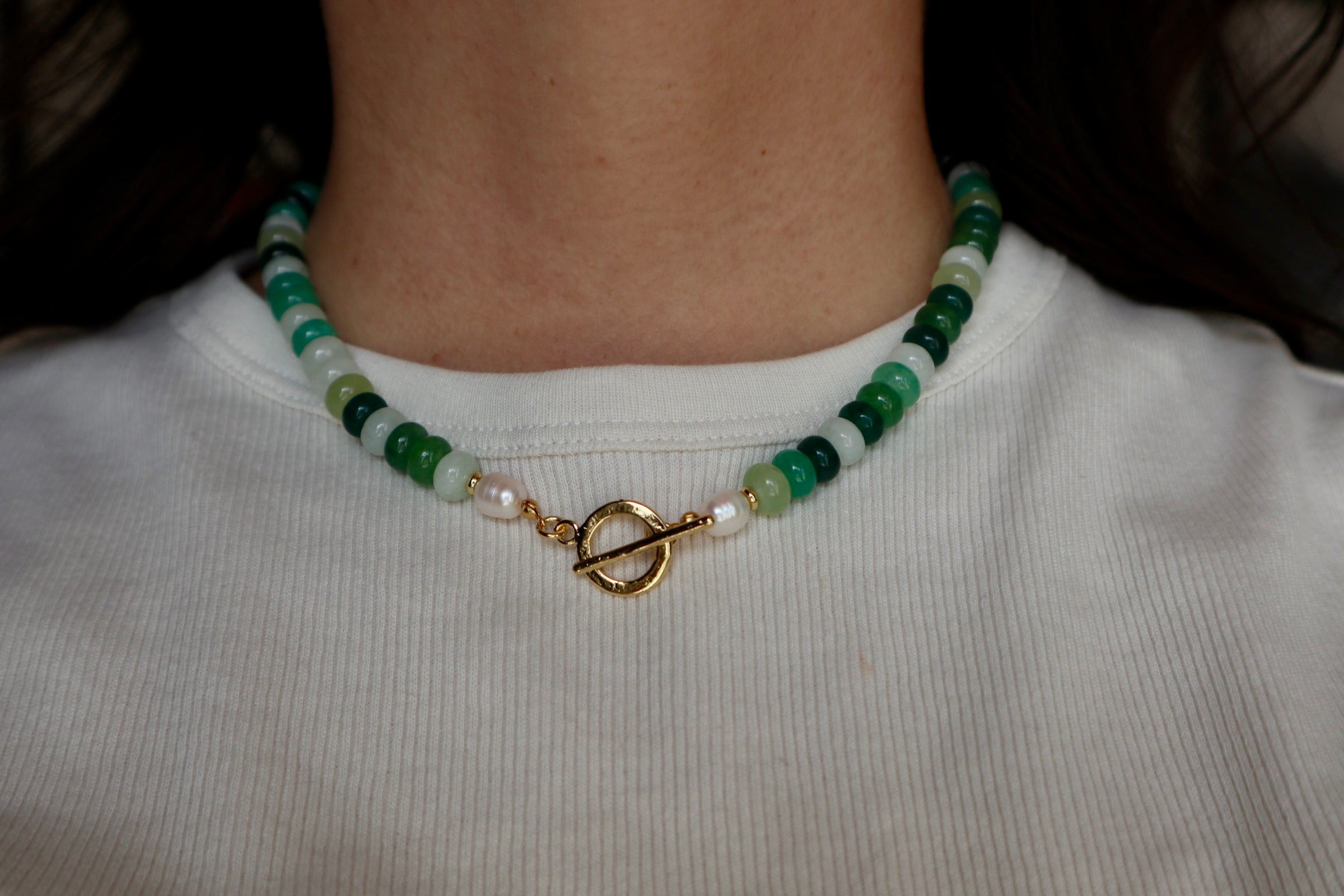 Verdelle necklace by Auréad Designs resting at the collarbone, styled with a white top, showing the full jade and pearl beaded strand