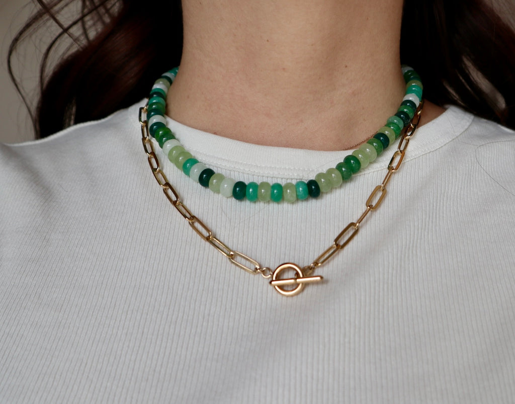 Verdelle jade and freshwater pearl necklace worn around the neck, front view, with gold toggle clasp