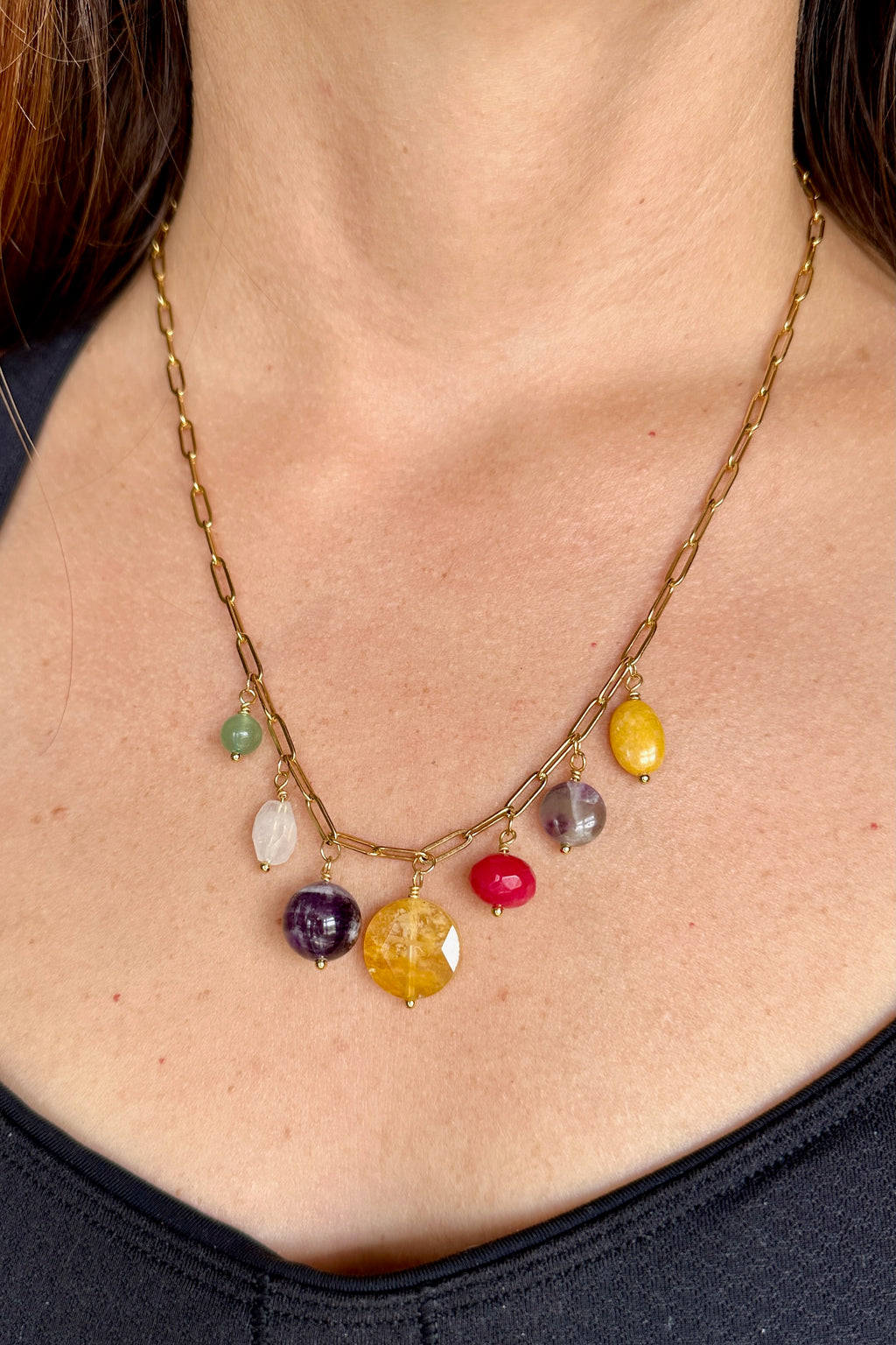 Wildflower necklace by Auréad Designs worn, showing the colorful gemstone drop cluster and gold paperclip chain