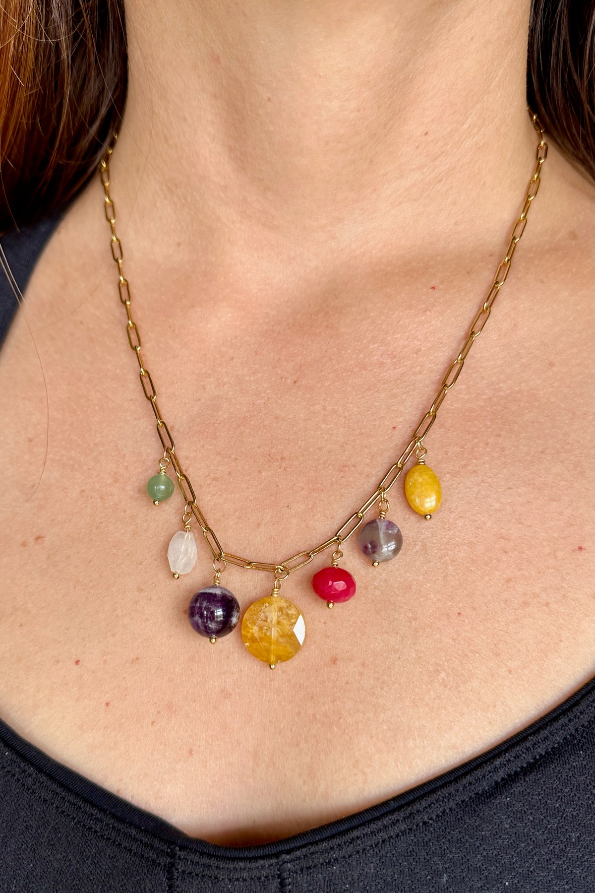 Wildflower necklace by Auréad Designs worn, showing the colorful gemstone drop cluster and gold paperclip chain