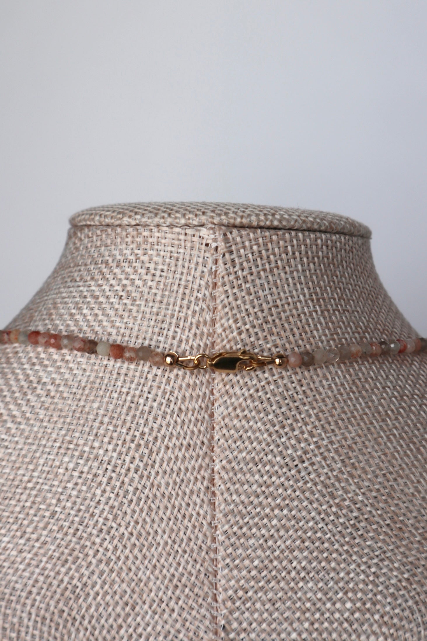 Back view of Calora necklace clasp — gold-filled lobster clasp and findings on a linen bust showing construction detail