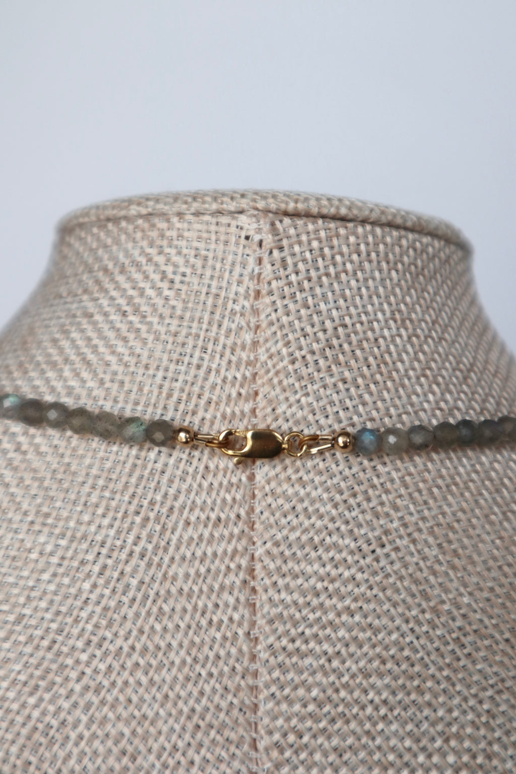 Back view of Liora necklace on linen bust showing 14k gold-filled lobster clasp and findings with labradorite beads visible on both sides