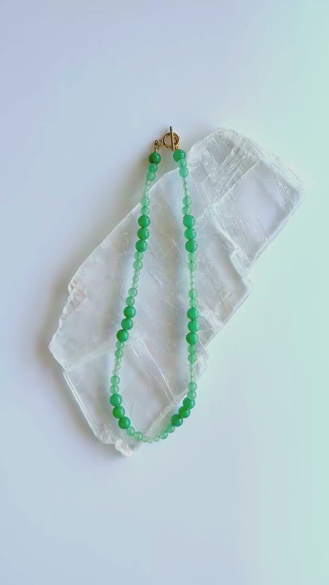Auréad Designs Aventine green aventurine beaded necklace with gold toggle clasp shown in motion, 18-inch length, displaying natural color variation from deep green to pale mint.